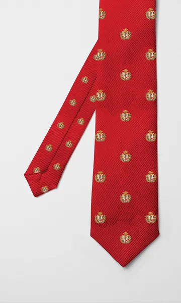 Corbata roja con el escudo colegial repetido en dorado